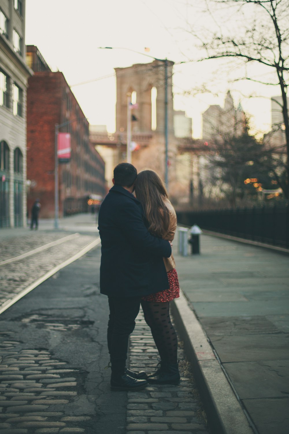 couple standing and hugging near trees