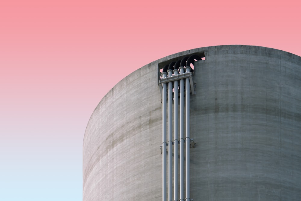 a tall building with a pink sky in the background