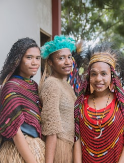 three women wearing seagrass skirts