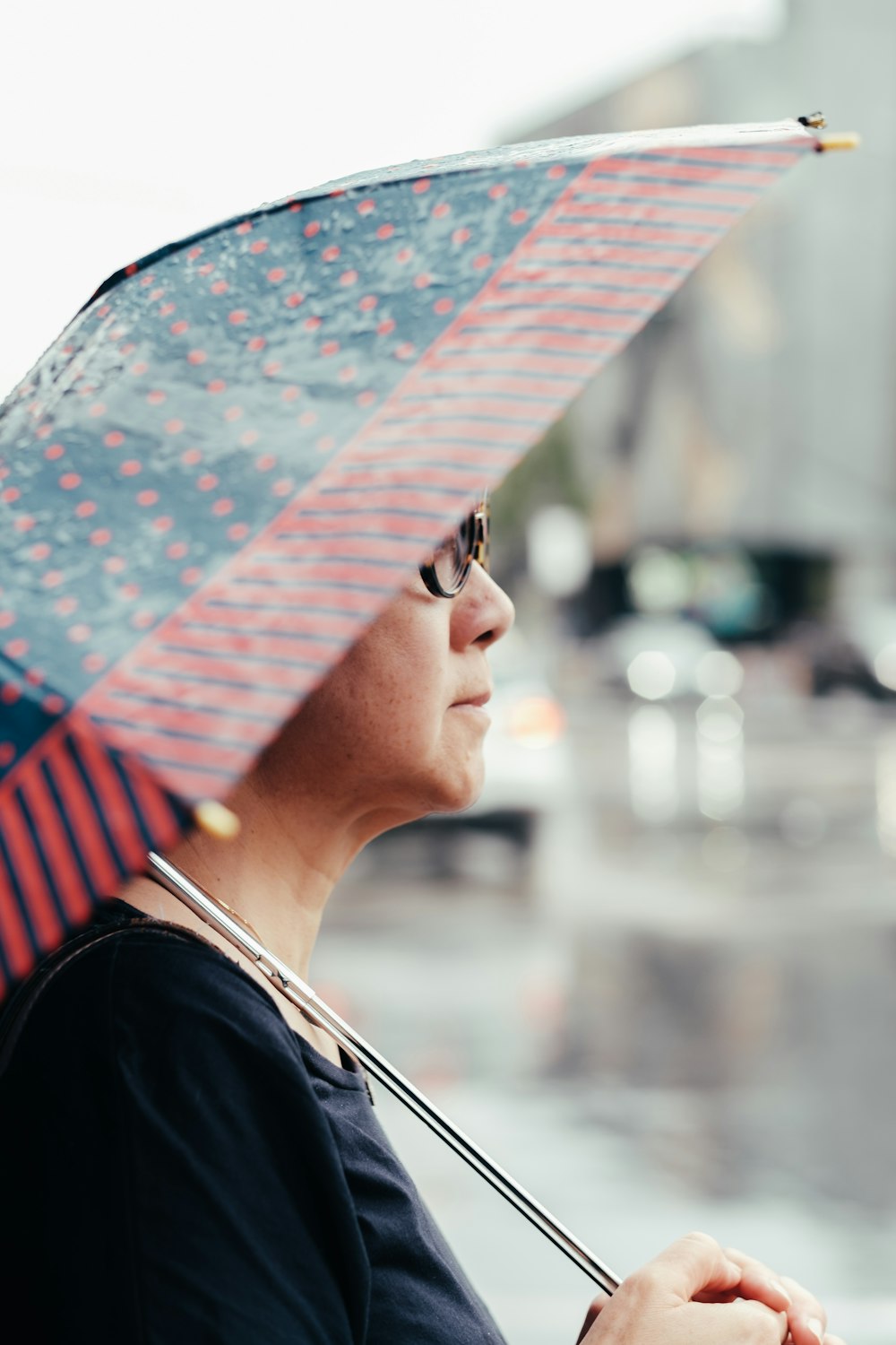 selective focus photo of woman holding umbrella