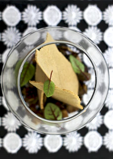 An overhead shot of a crisp tasting setup with tasting notes and a variety of crisps laid out.