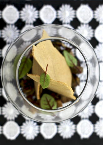 An overhead shot of a crisp tasting setup with tasting notes and a variety of crisps laid out.
