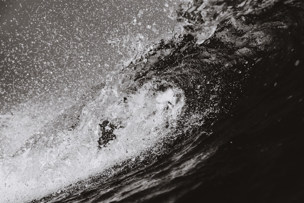 grayscale photo of barrel wave