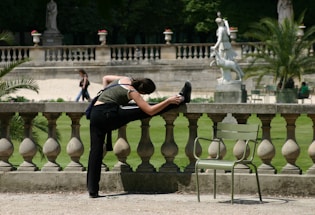 A person stretching in a modern urban park.