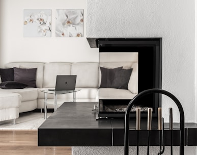white sectional sofa and black table