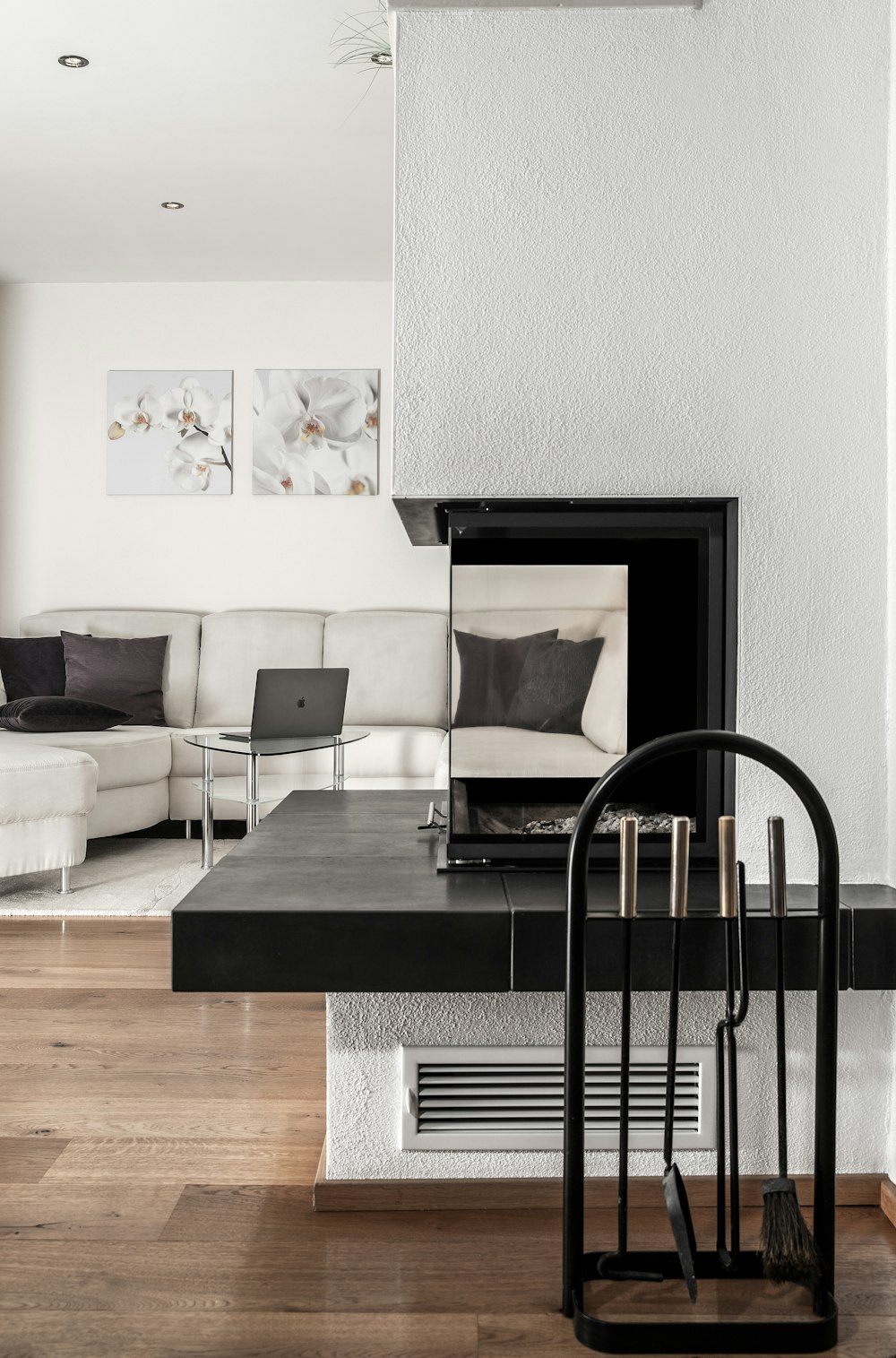 white sectional sofa and black table