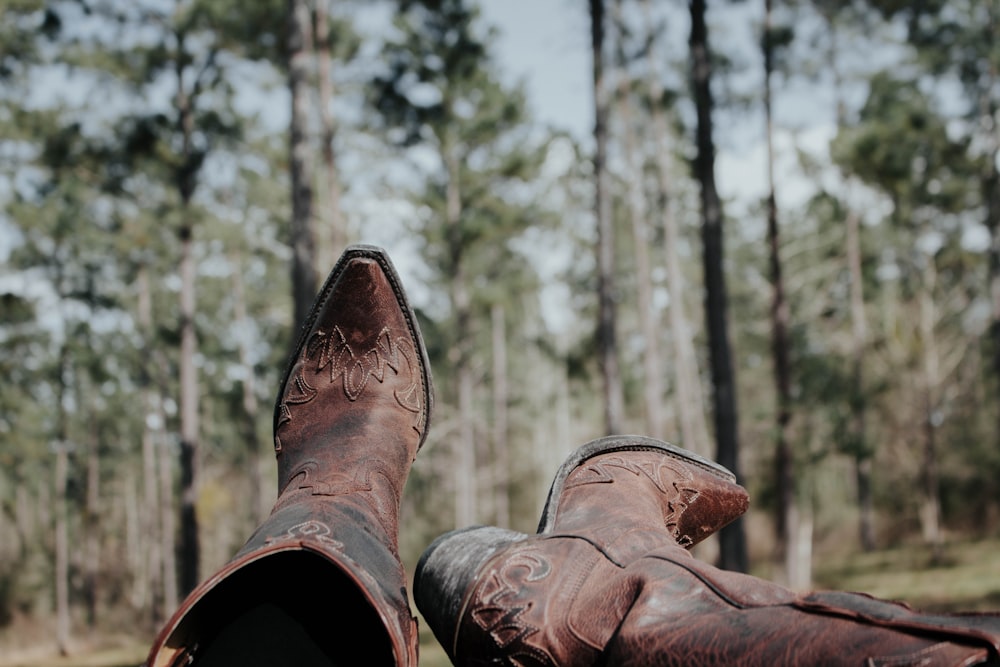 selective focus photography of person wearing cowboy boots