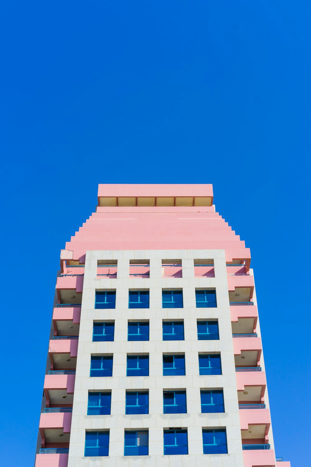 Edificio de hormigón blanco bajo el cielo azul durante el día