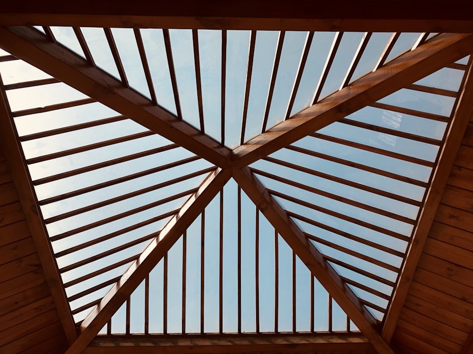 low angle photography of brown wooden house ceiling
