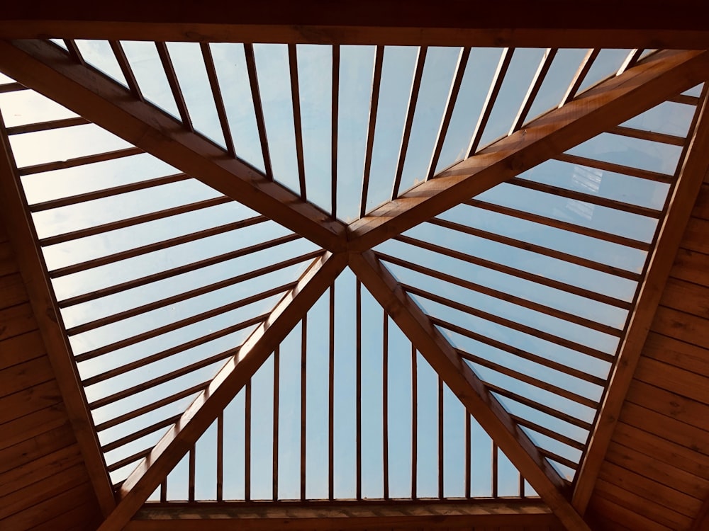 low angle photography of brown wooden house ceiling