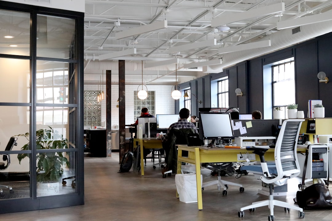 people working inside white and black room