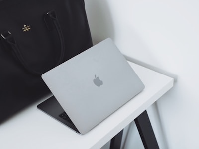 A sleek laptop bag resting next to a modern workspace.