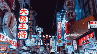 Colorful LED sign with dynamic lighting effects on a busy street.