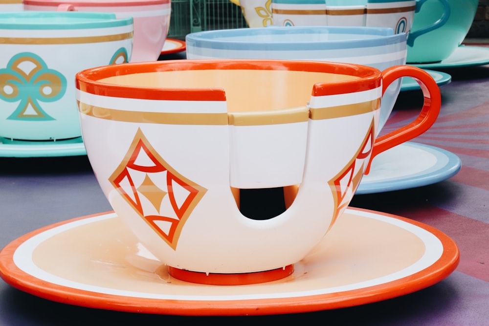 white and red ceramic teacup on saucer