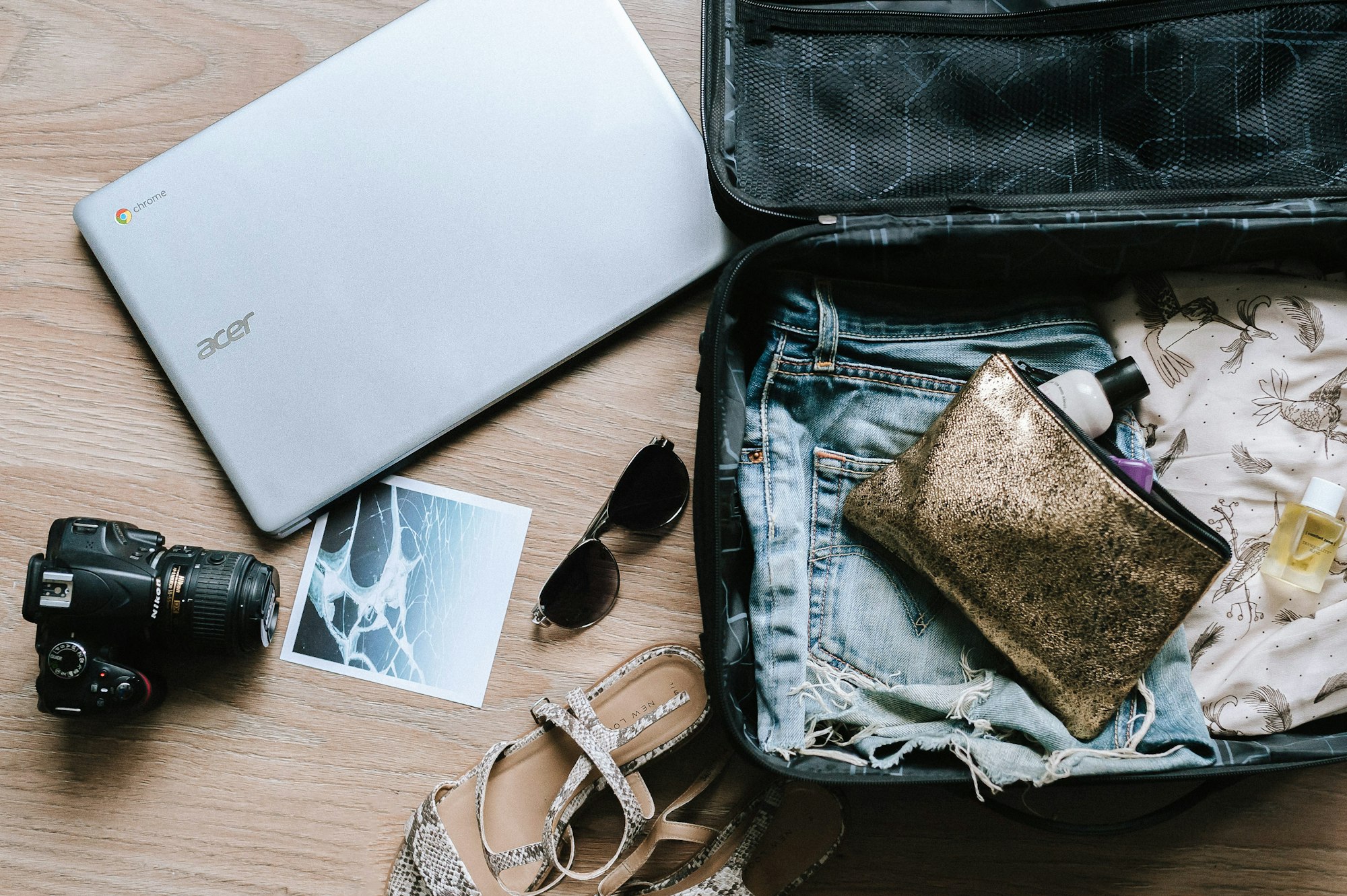 black DSLR camera near sunglasses and bag- best travel laundry bag
