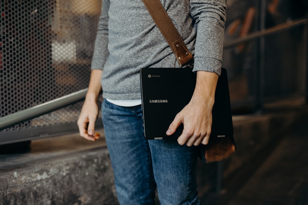 person holding black laptop computer