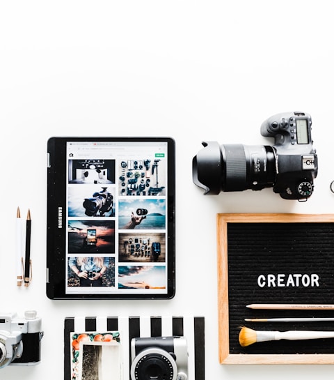 flat view of cameras beside computer tablet and smartphone