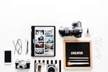 flat view of cameras beside computer tablet and smartphone