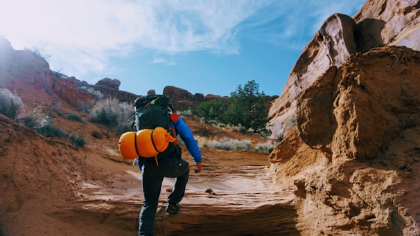 person climbing on rock