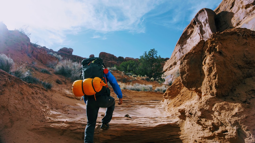 person climbing on rock