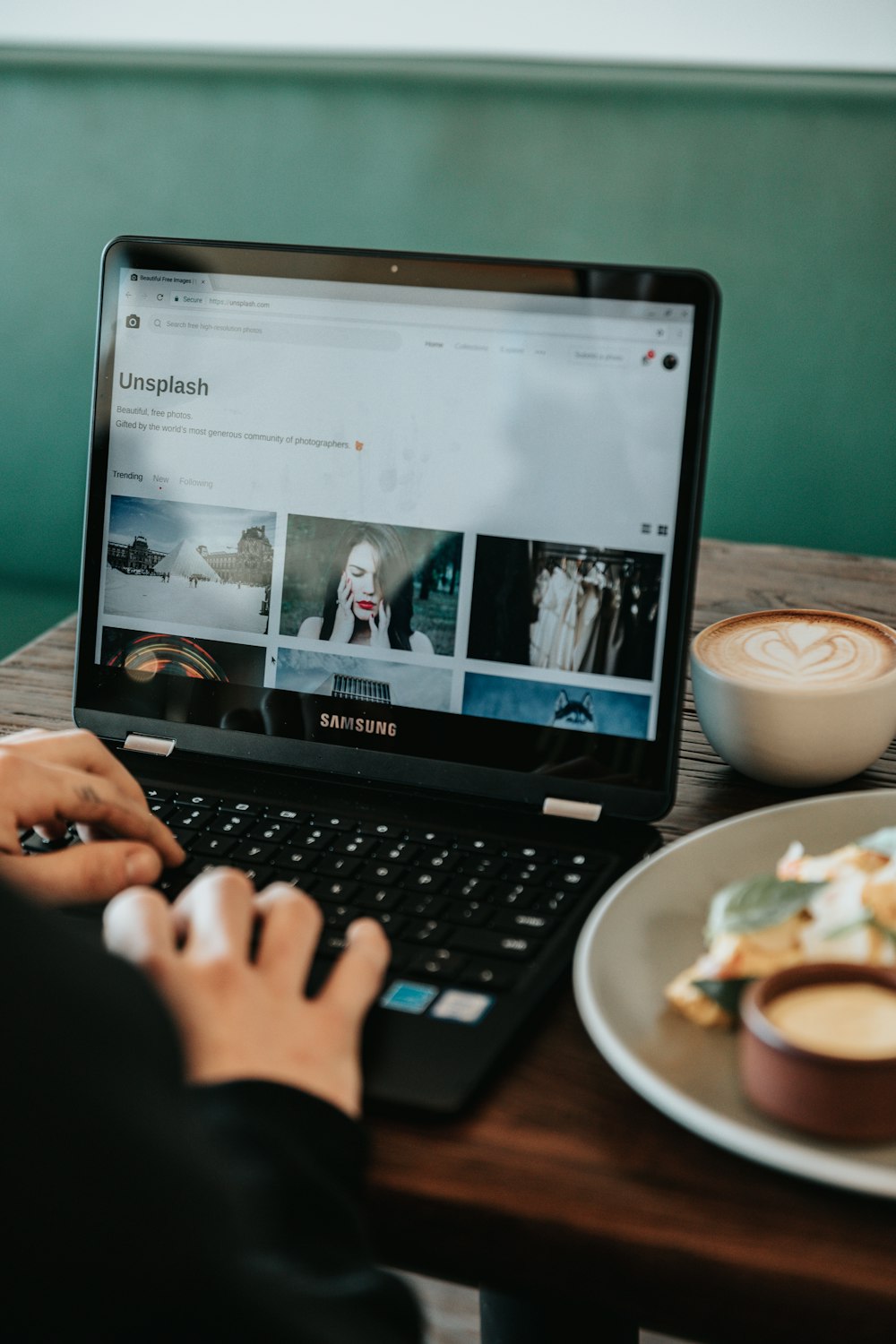 person holding black Samsung laptop