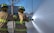 Firefighters practicing hose deployment during a daytime training drill in an open field.