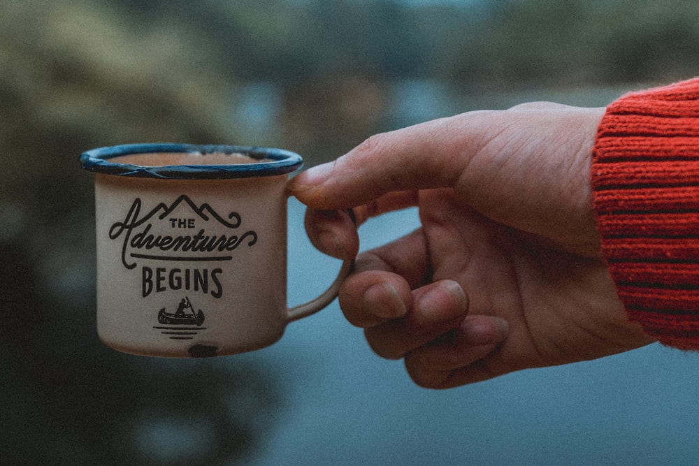 person holding mug