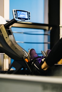 Close-up of feet pedaling a stationary bike with sporty shoes