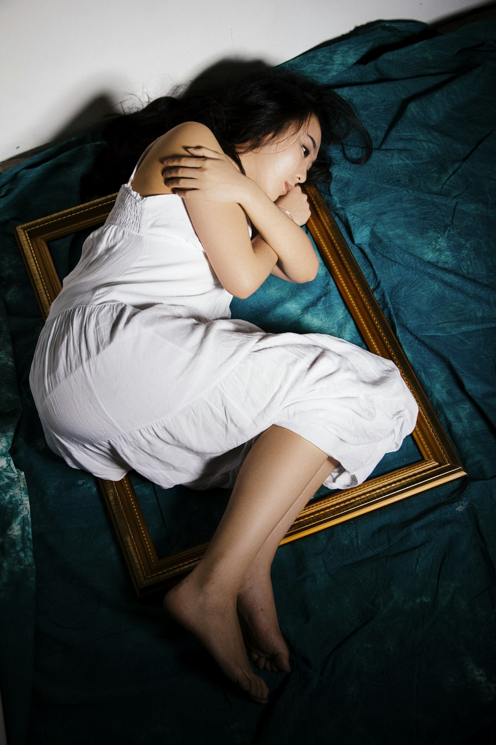 woman in white dress laying photo frame