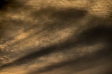 Moody shot of a sleek private jet silhouetted against a twilight sky.