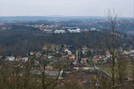 A panoramic view of a residential area with various houses and green spaces.