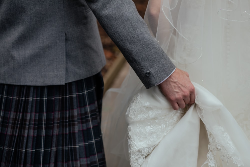 person holding white wedding gown