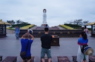 Pilgrims gathered in quiet reflection near the historic statue of Saint Thomas.