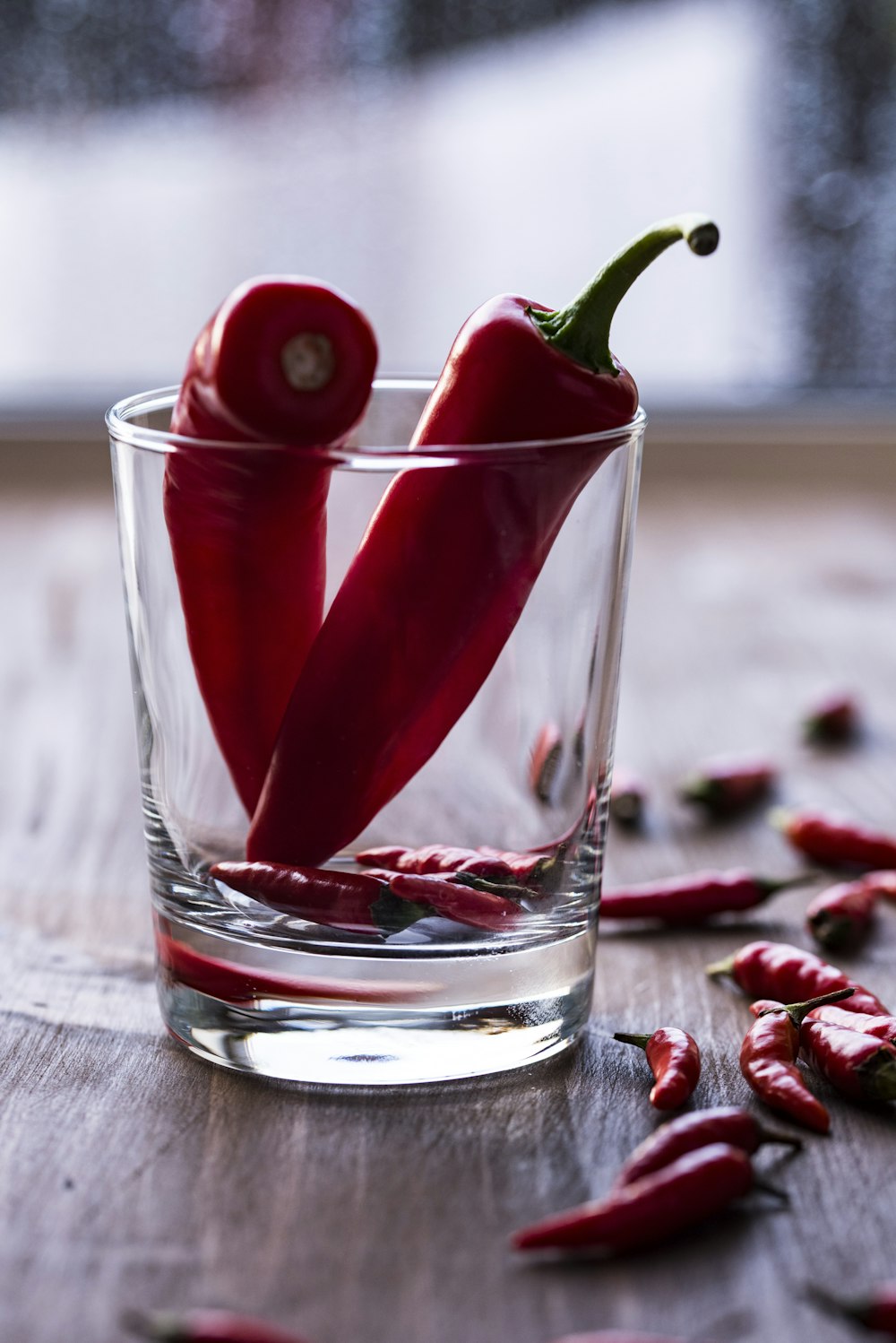 two red chilies in clear shot glass