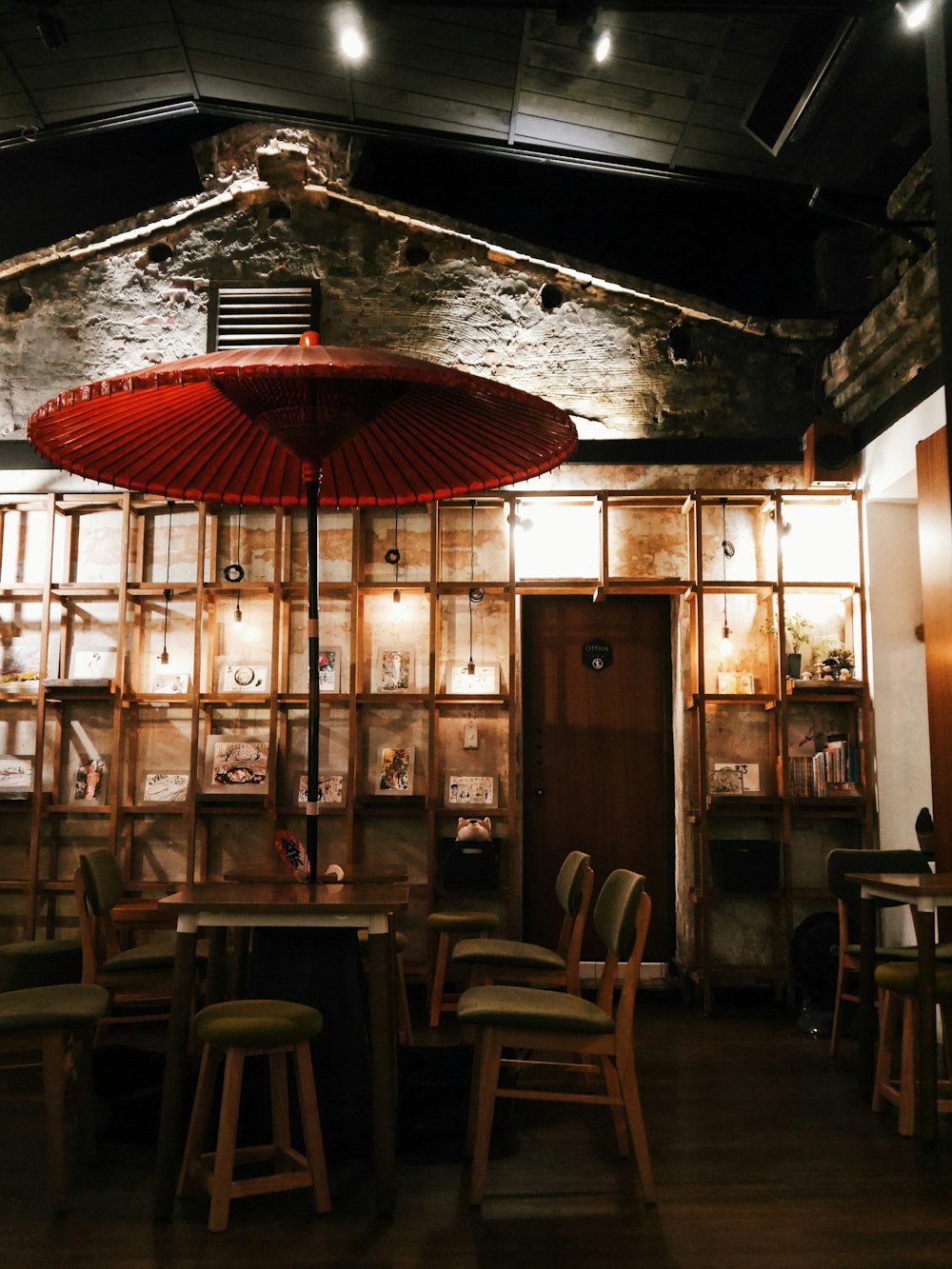 red patio umbrella and brown wooden table and chairs