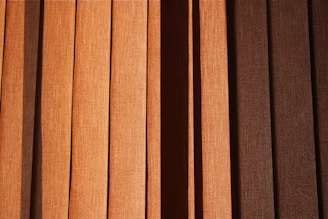 a close up of a window with brown blinds