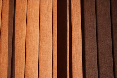 a close up of a window with brown blinds