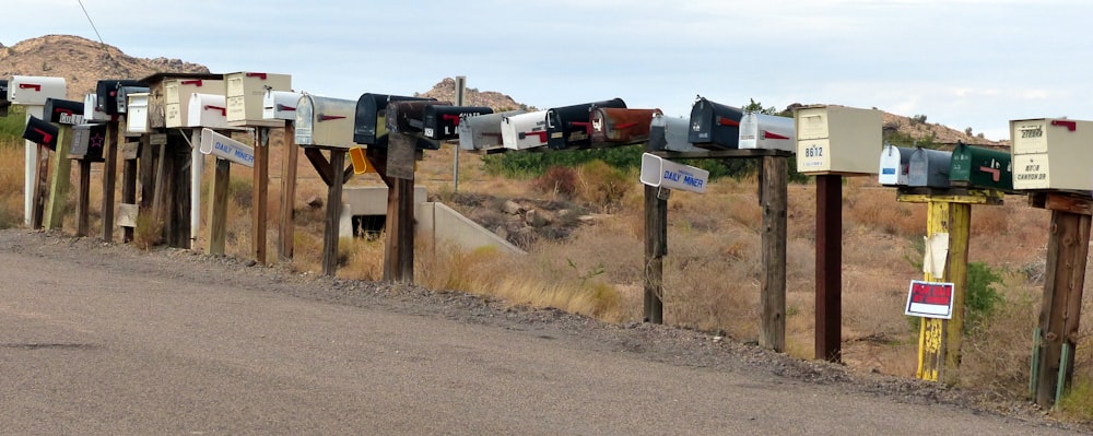 assorted-color mail bot lot on gray concrete road