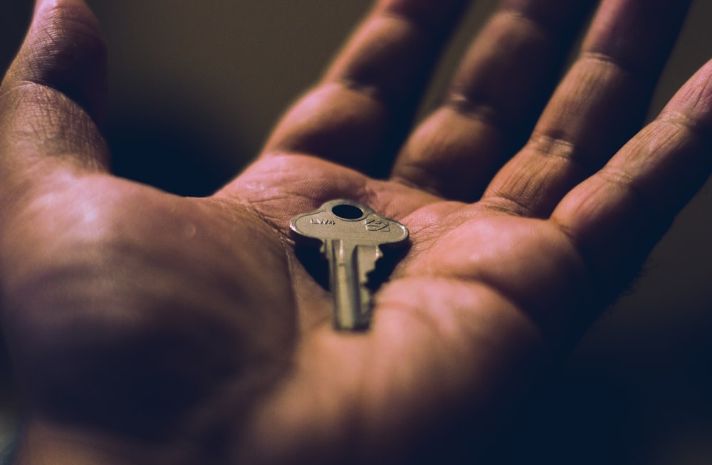 person holding key