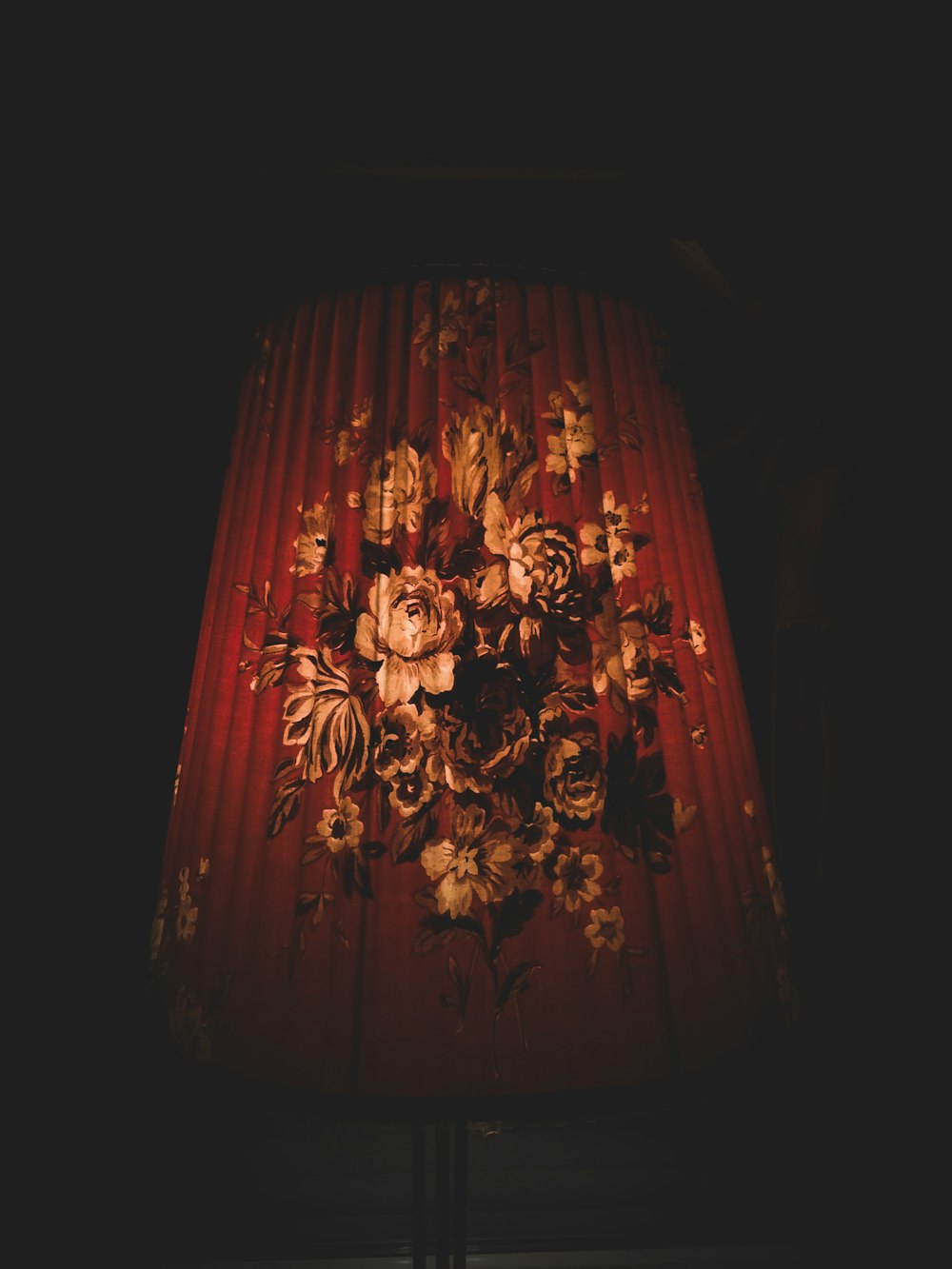 closeup photo of red and brown floral lampshade