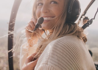 woman in white knit sweater inside aircraft