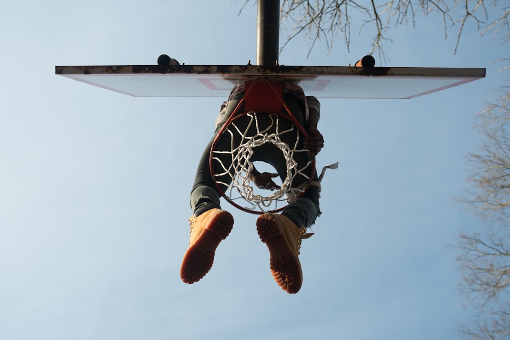 person sitting on basketball ring