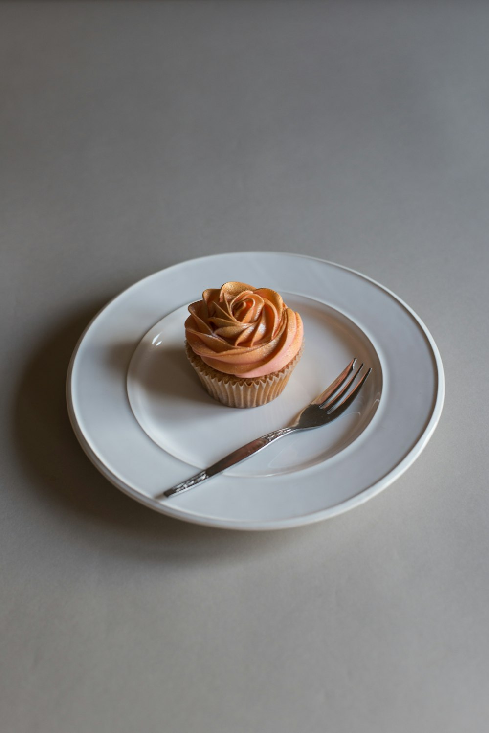 round ceramic plate with cupcake on top