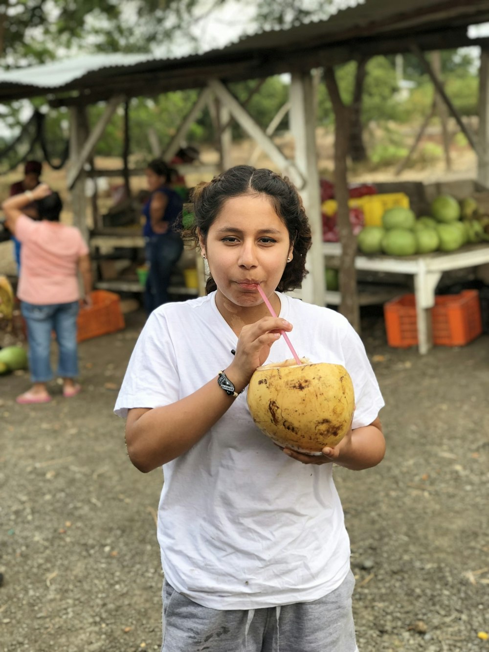 woman sipping coconut fruit