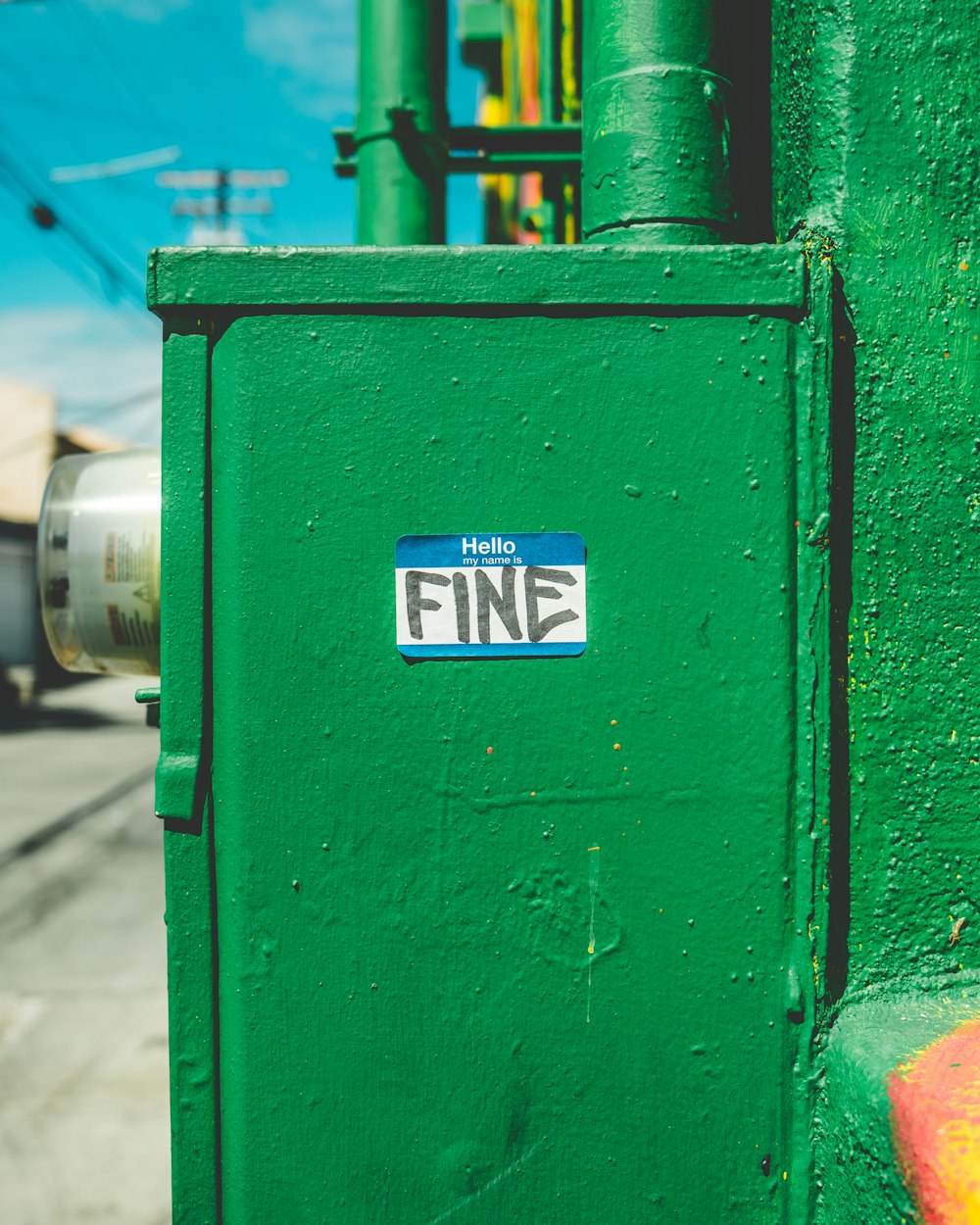 green steel box with fine-printed sticker