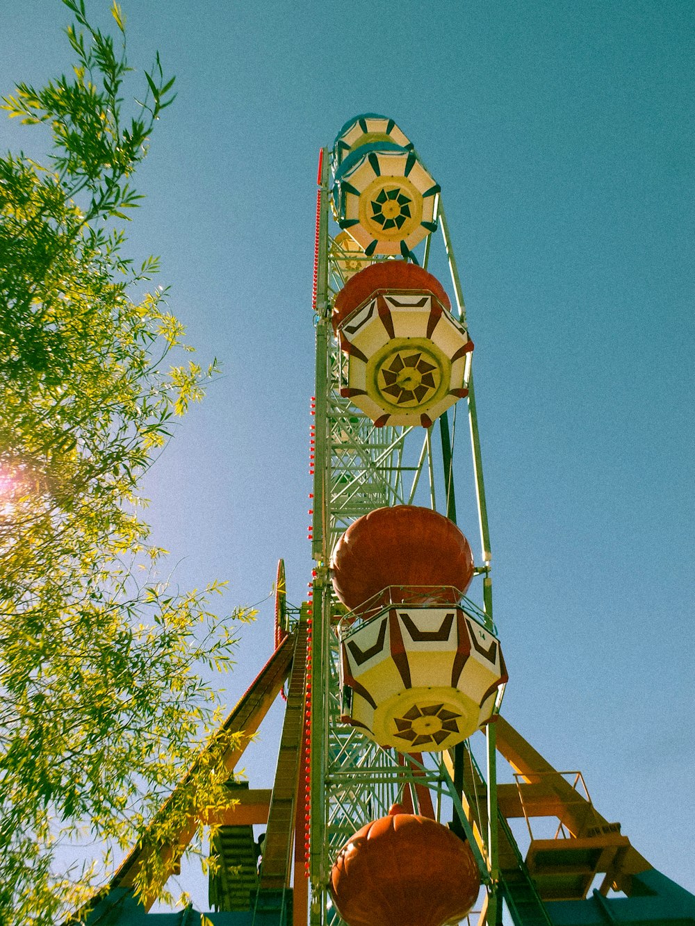 low-angle photography of green ferris wheel