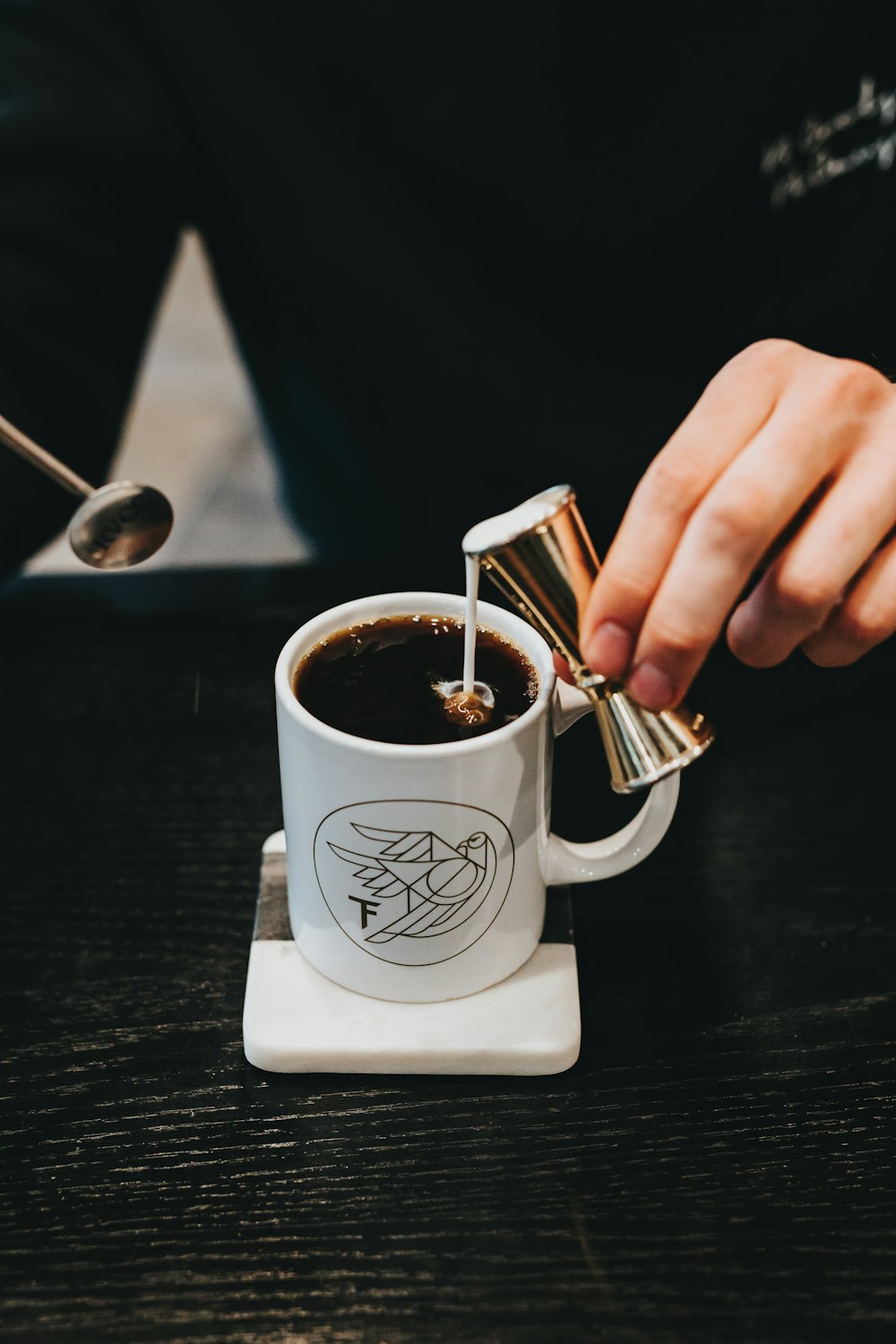 milk pouring on coffee