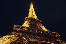 The Eiffel Tower illuminated at night, showcasing its beauty.