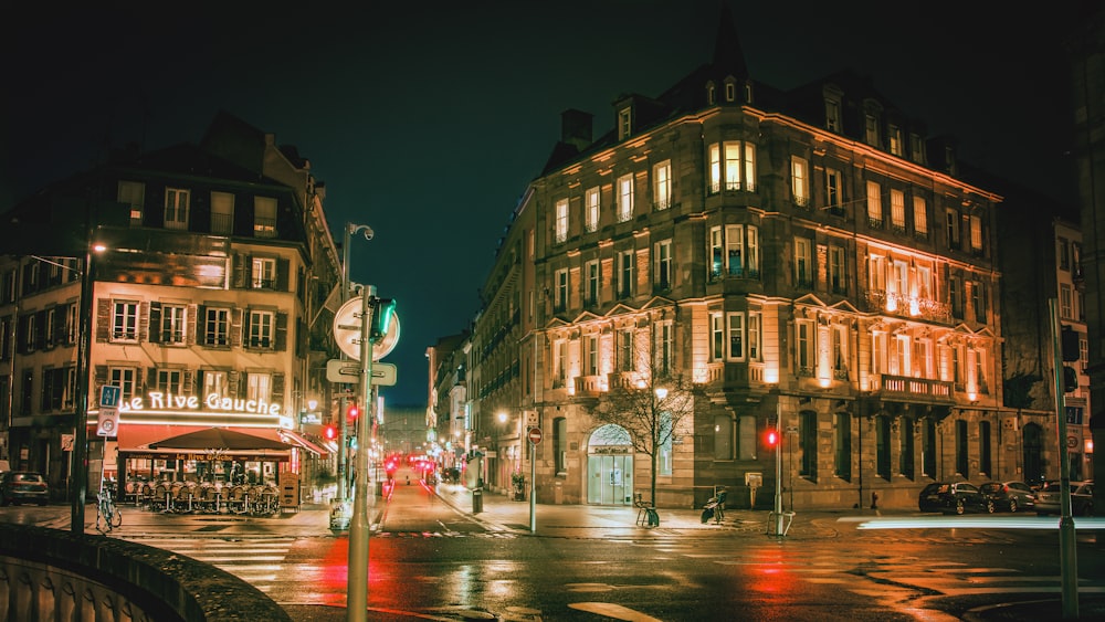 street photography of roads between buildings at night