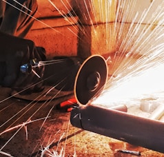 person grinding pipe steel wool photography